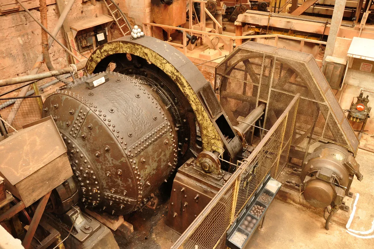 Industrial ball mill used for grinding gold ore in a mineral processing plant